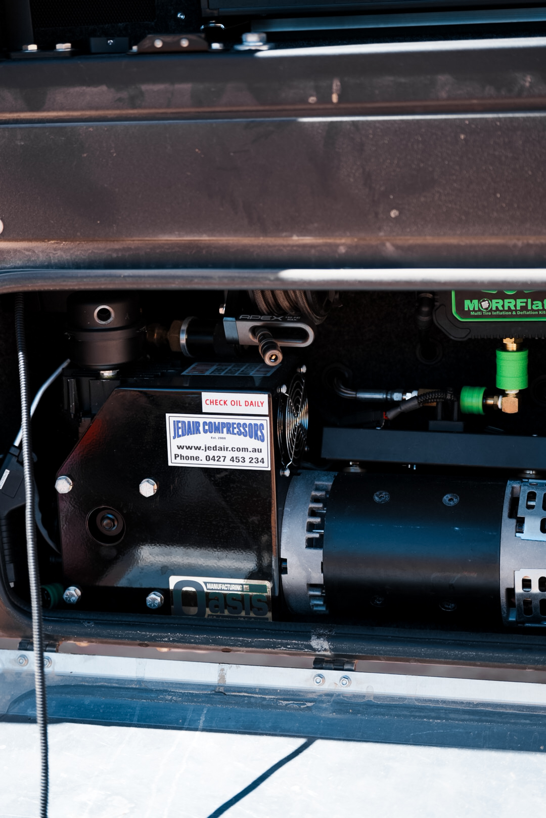 Jedair Oasis 12V compressor mounted inside the side access compartment of the Waking up in Aus touring rig